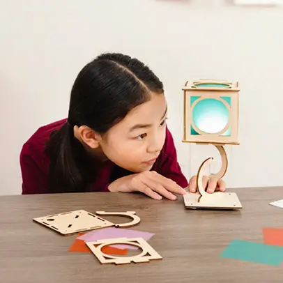 Student learning physics principles with a KiwiCo Levitating Lantern kit.