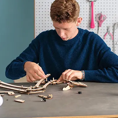 High schooler assembling a Eureka Crate classroom engineering kit.