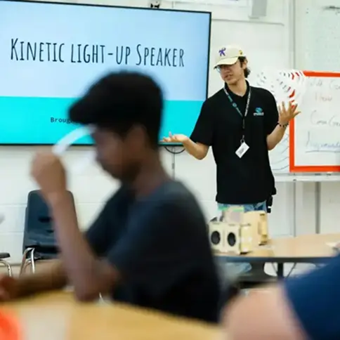 Student building a kinetic speaker using a KiwiCo classroom STEM kit designed for science and engineering lessons.