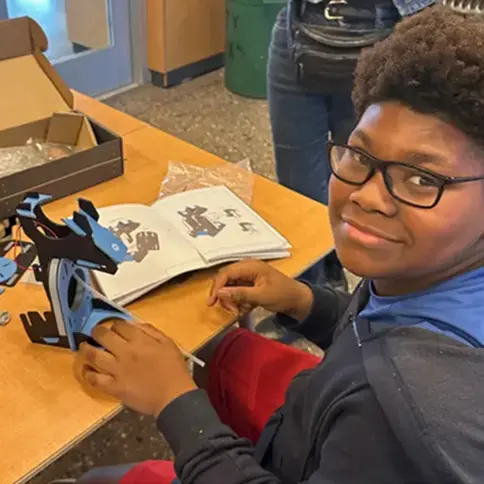 Student assembling a KiwiCo soap dispenser STEM project as part of a hands-on classroom science kit.