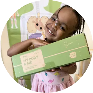 A child holding a Kiwi Crate subscription box