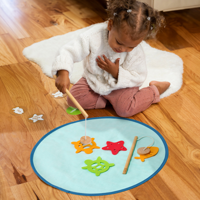 Child playing with the Fishing Game Play Set from KiwiCo Panda Crate